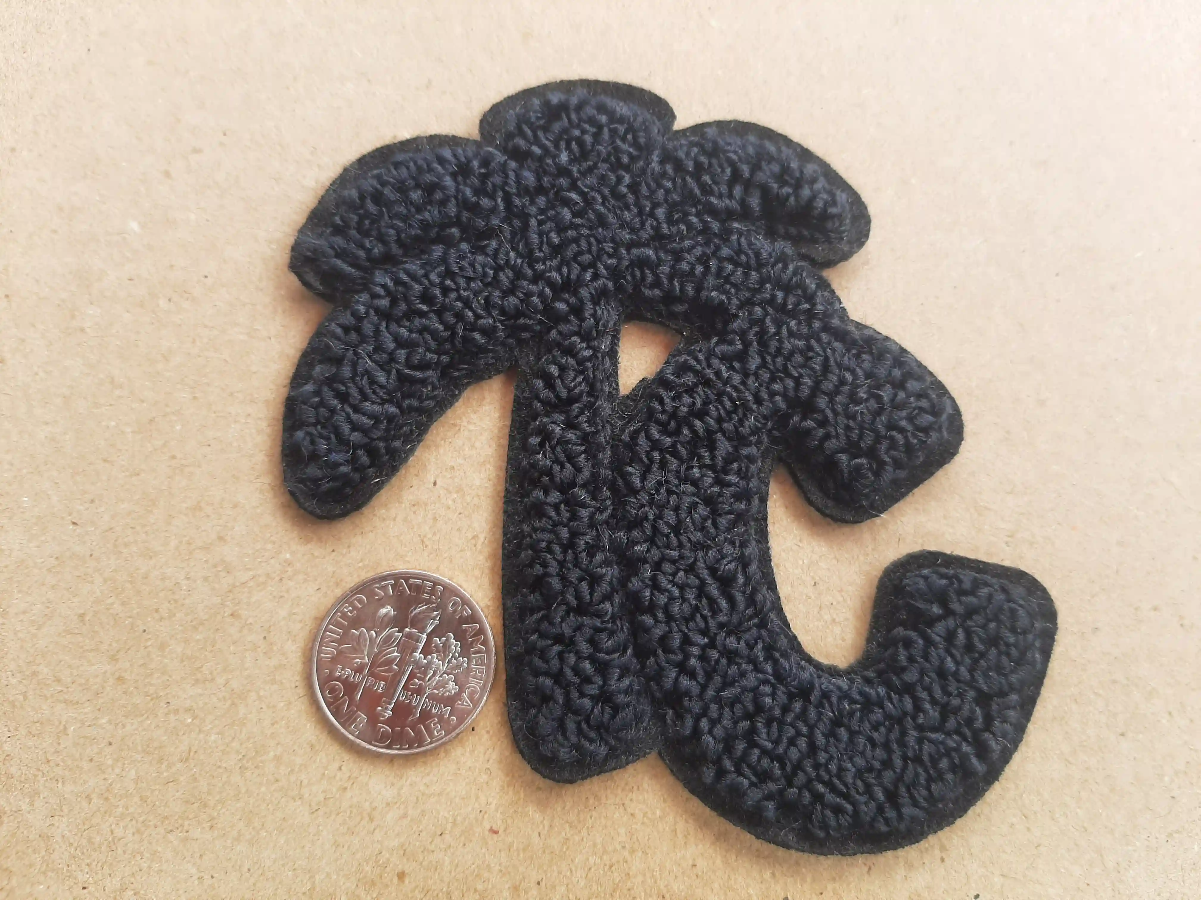 Chenille Scrim Felt beautiful single color black T C Text with palm tree making up for the T in TC. Smaller Size – Chenille Patches