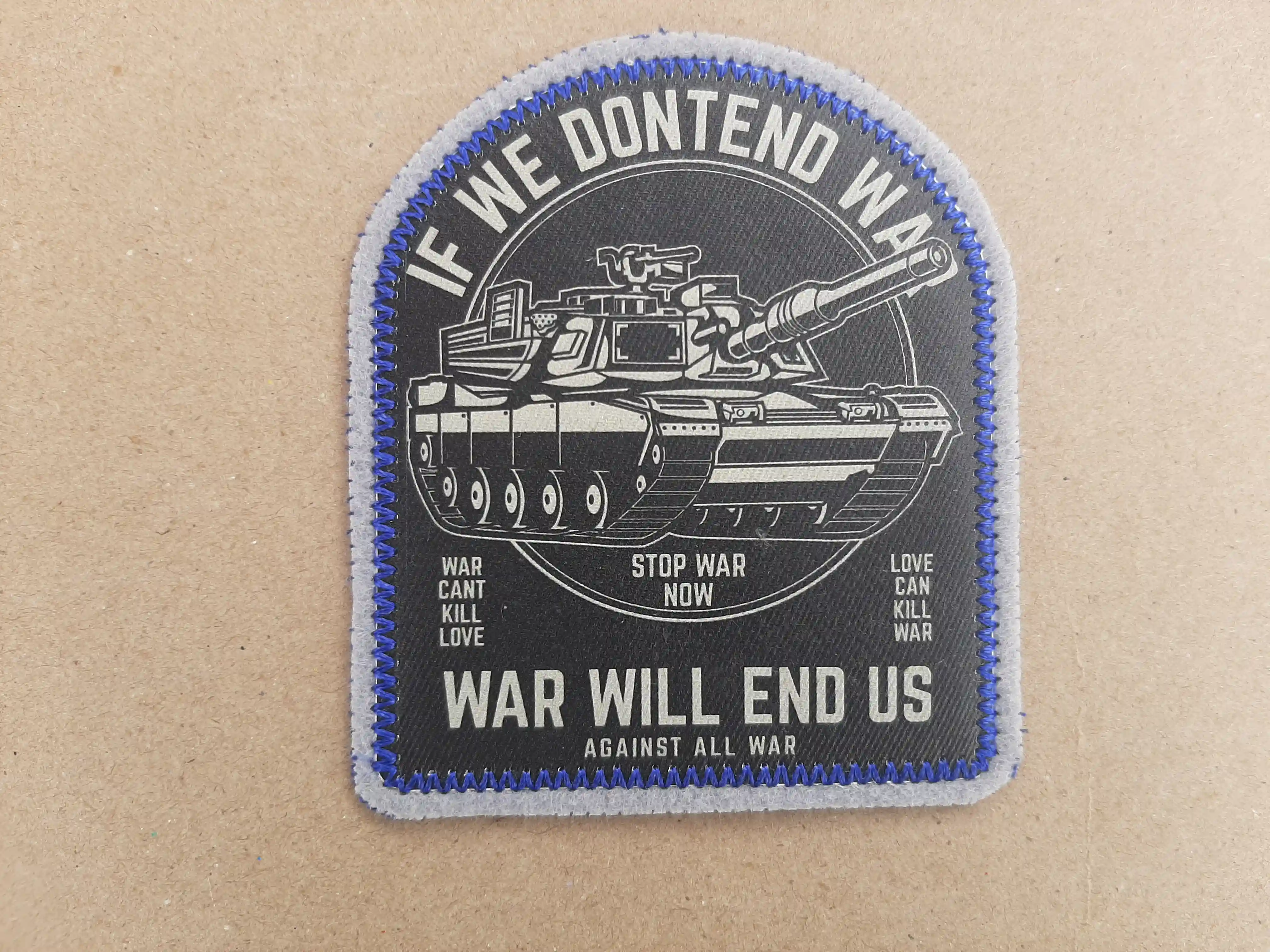 Tank image with clear text IF WE DONT END WAR. WAR WILL END US. A clean black and white image with a stylish blue merrow border. Love conquers all – Sublimated Patches