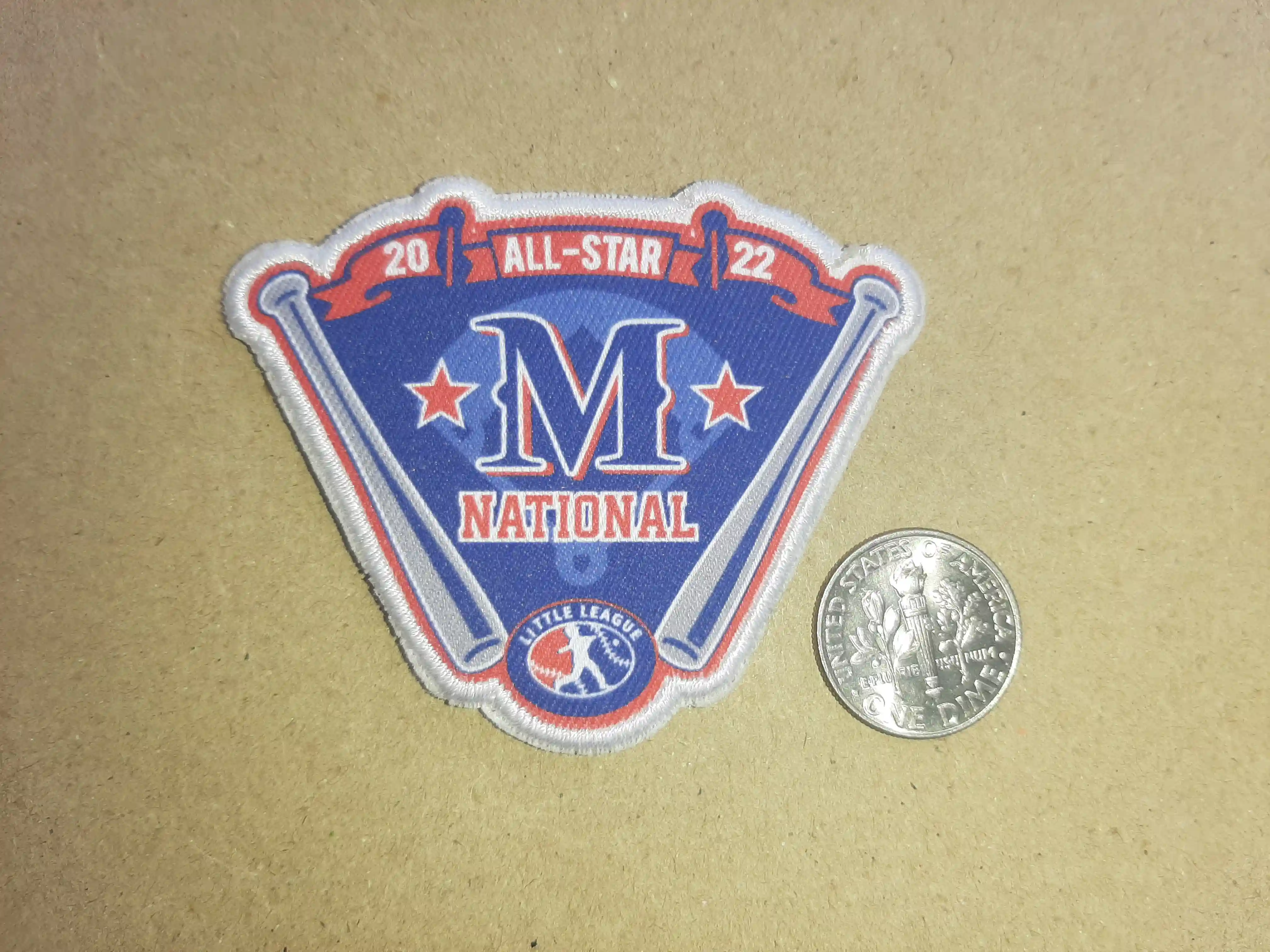 2022 Blue shade with Red Ribbon with stars the baseball bat and the text M National – Woven Patches